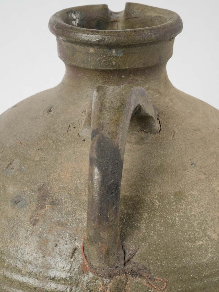Ribbed patina-detailed matte green clay pitcher