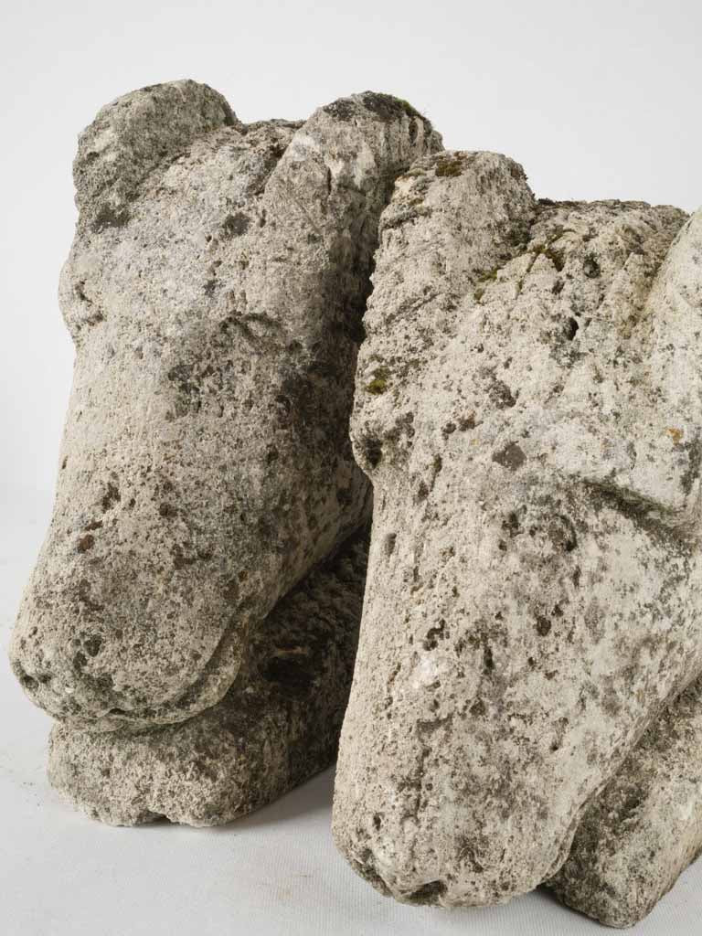 Pair of salvaged carved stone ram heads from a church 14¼"
