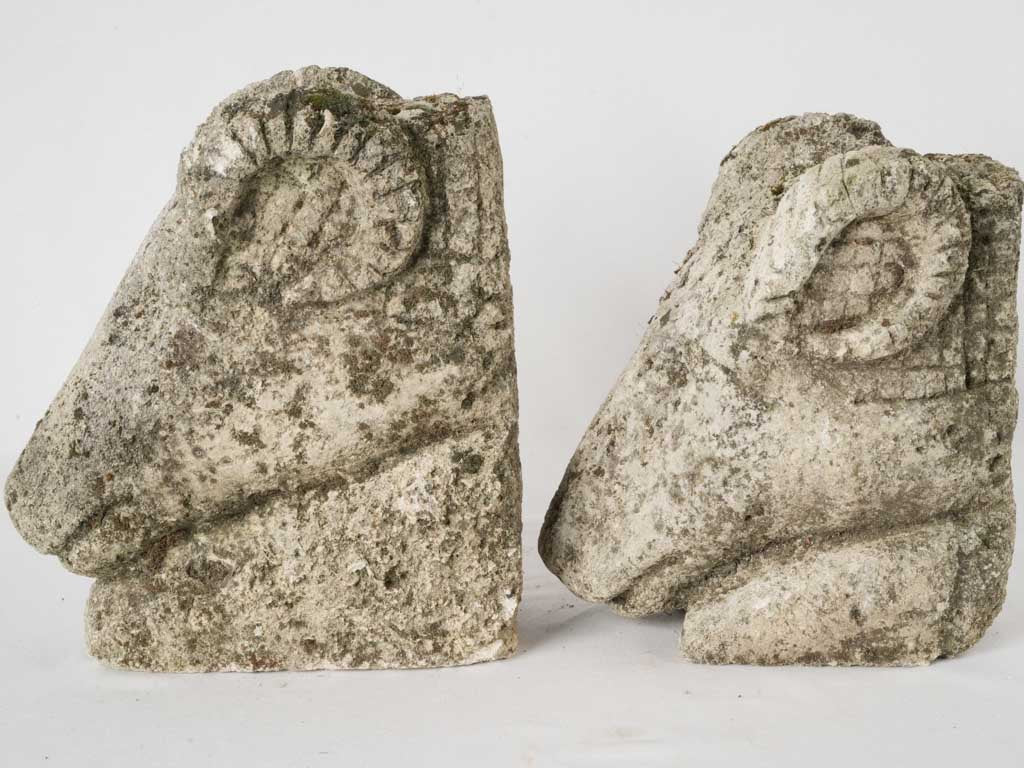 Pair of salvaged carved stone ram heads from a church 14¼"