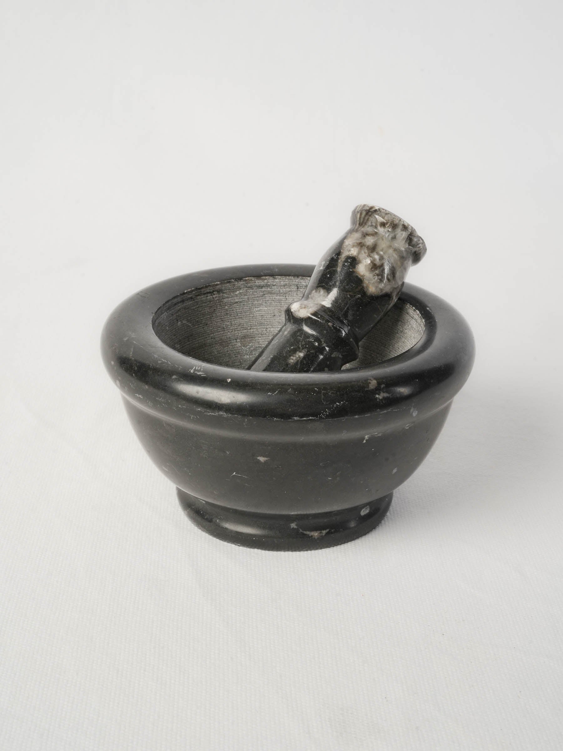 Black stone-textured mortar and pestle