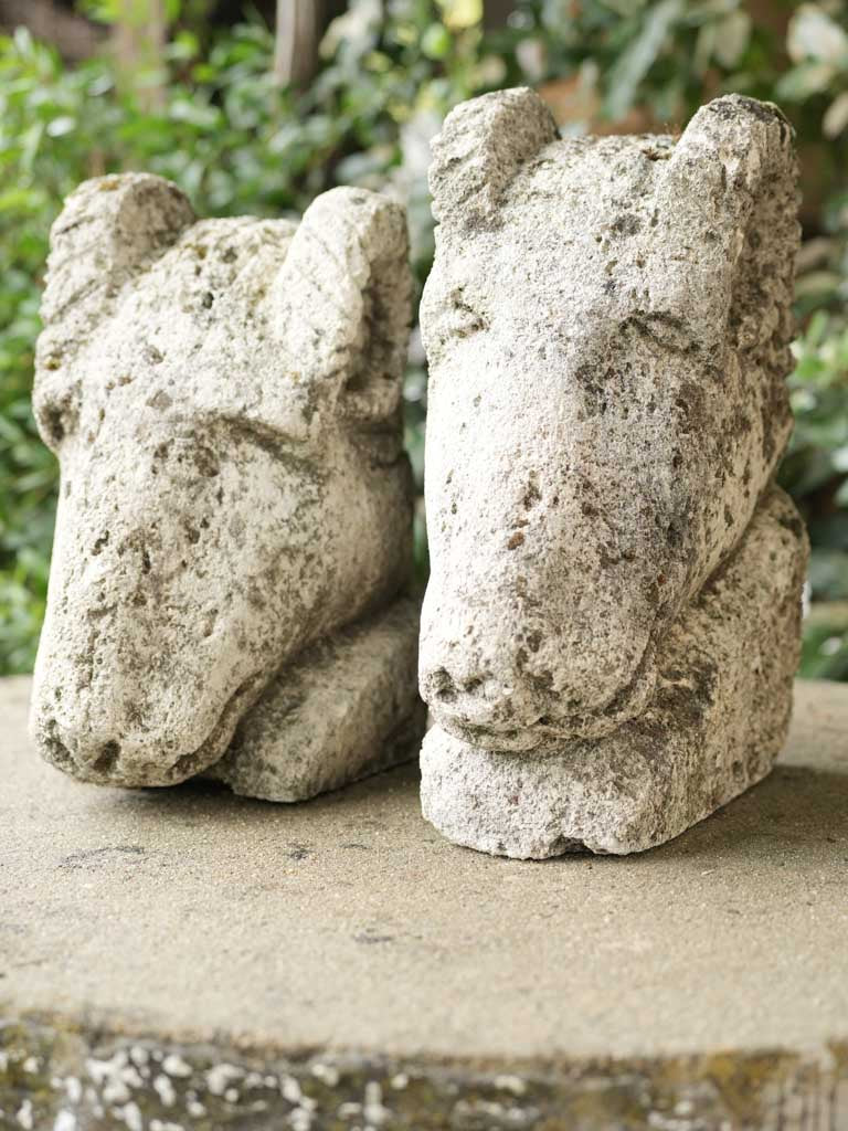 Pair of salvaged carved stone ram heads from a church 14¼"
