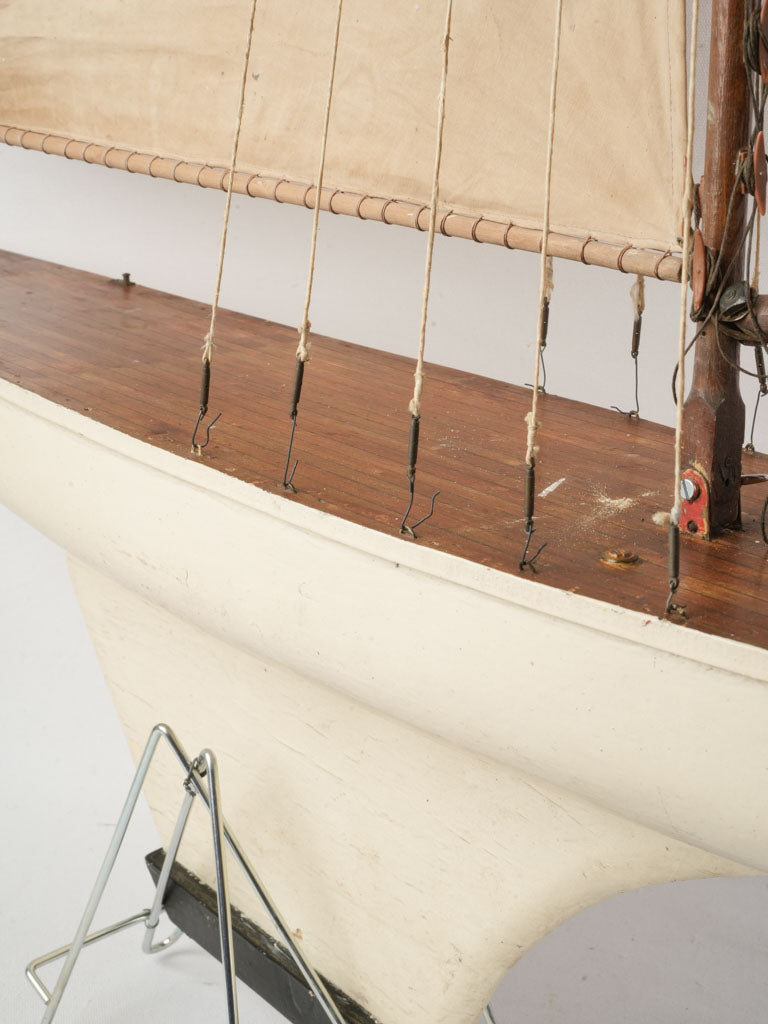 Cream-colored sails model yacht