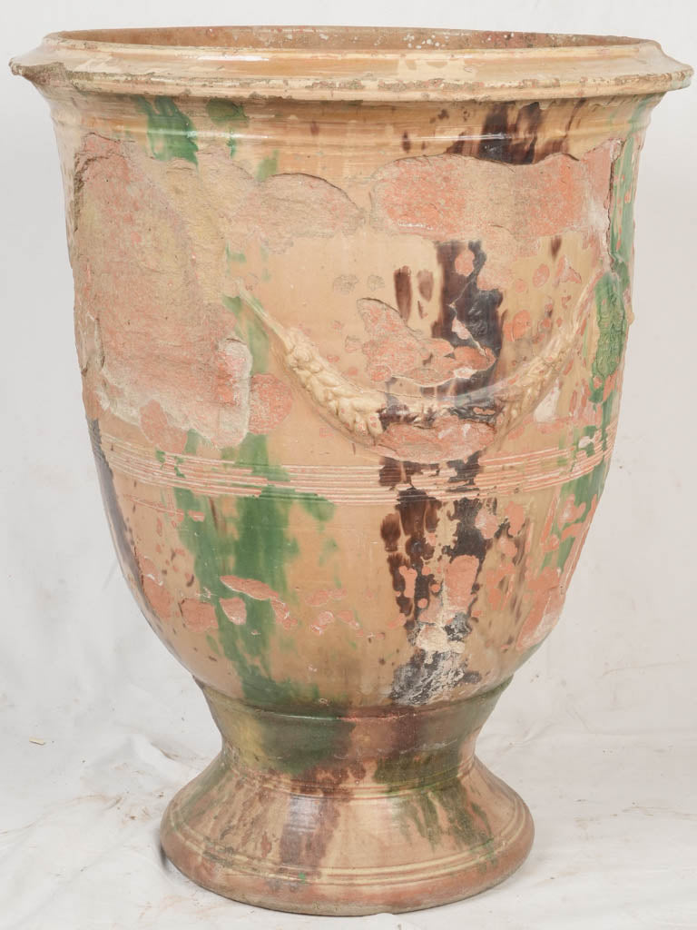 Rustic ochre, green, and black glazed urn