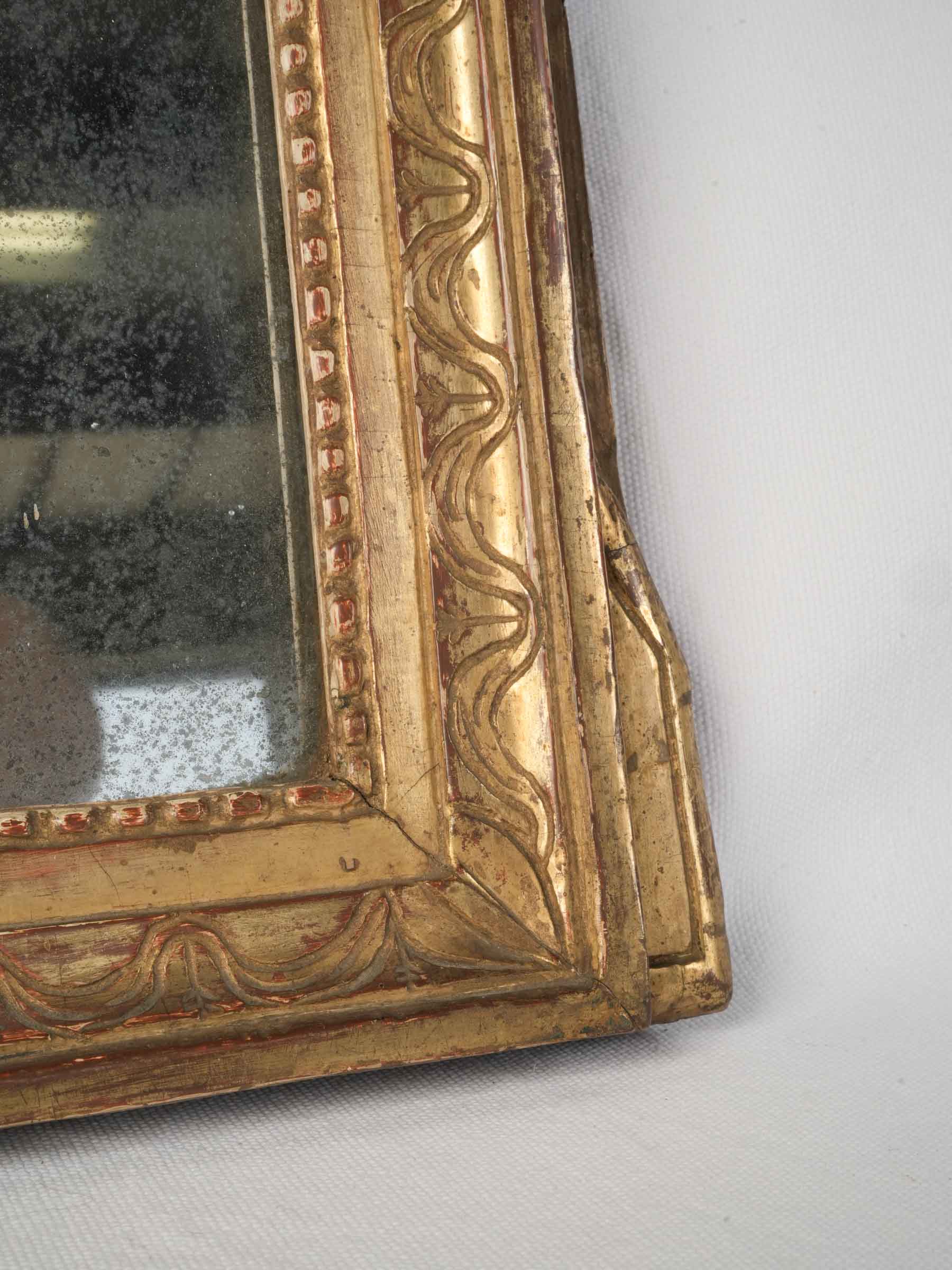 Richly detailed laurel motif mirror