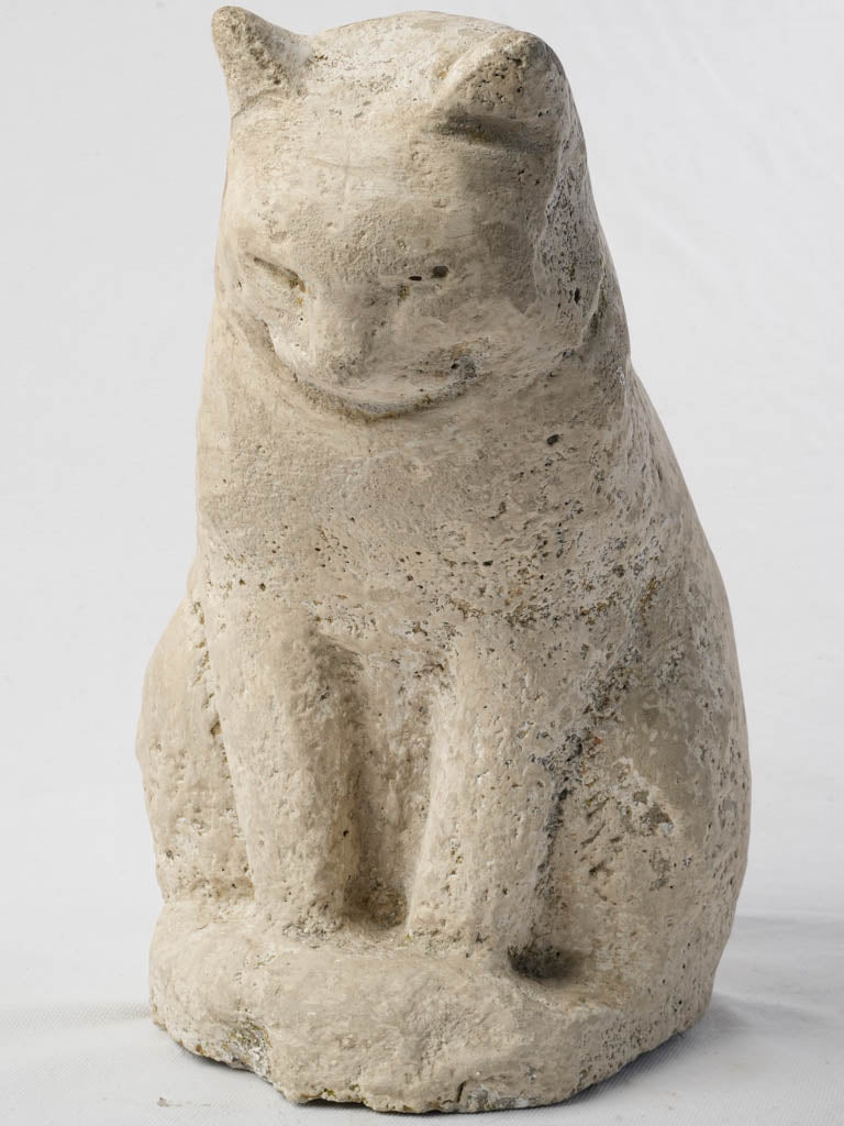 Charming patinated stone cat sculpture