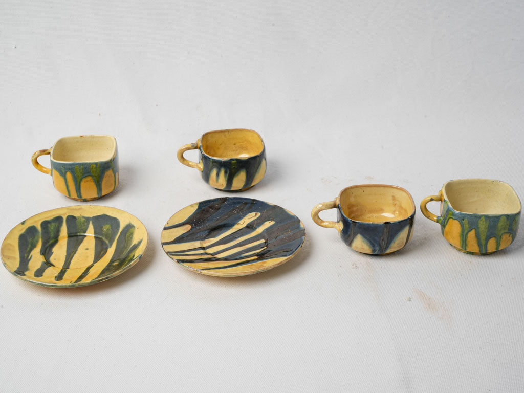 Vibrant French ceramic cups with saucers
