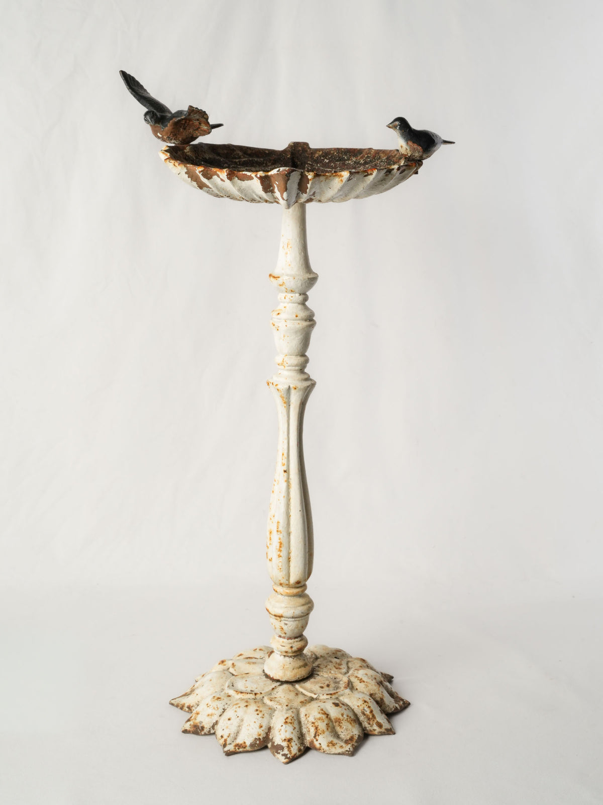Weathered French birdbath with birds