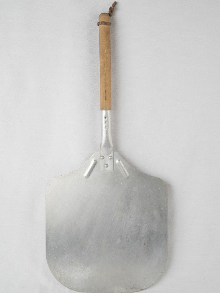 Rustic metal pizza pelle with wood handle
