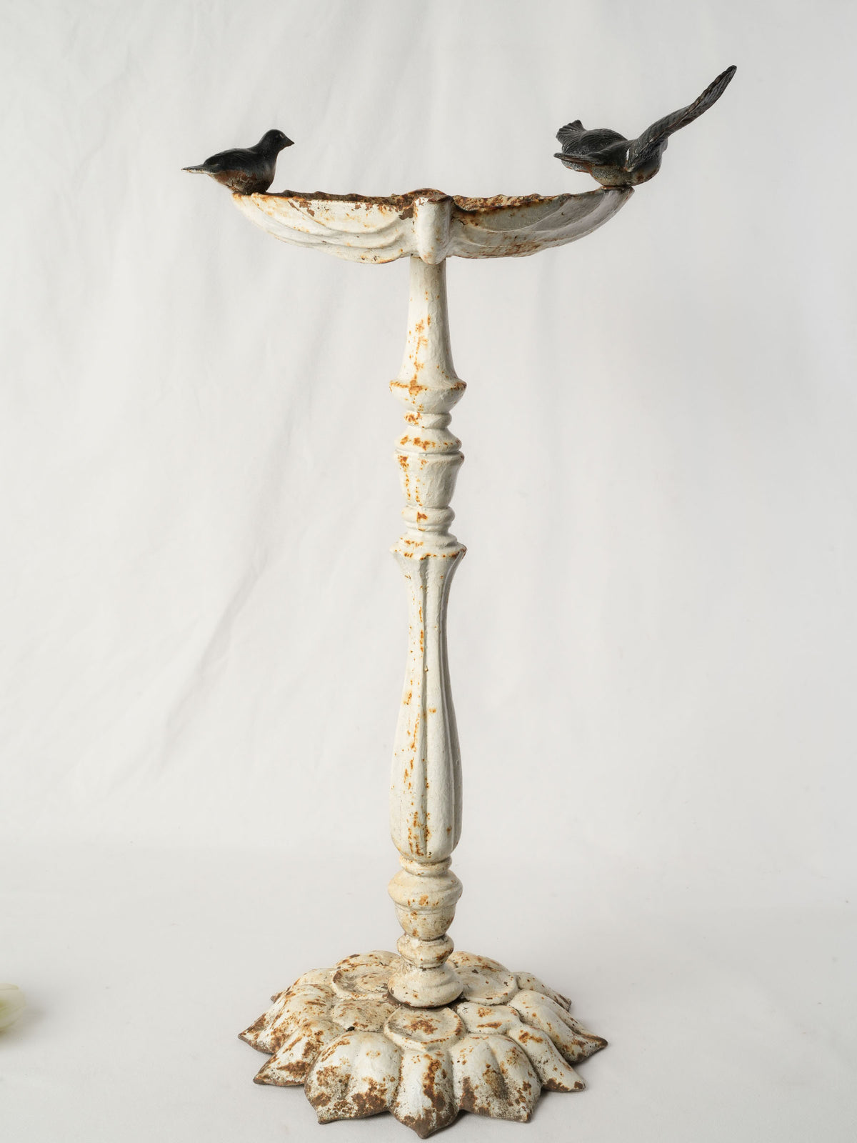 Painted antique cast-iron birdbath