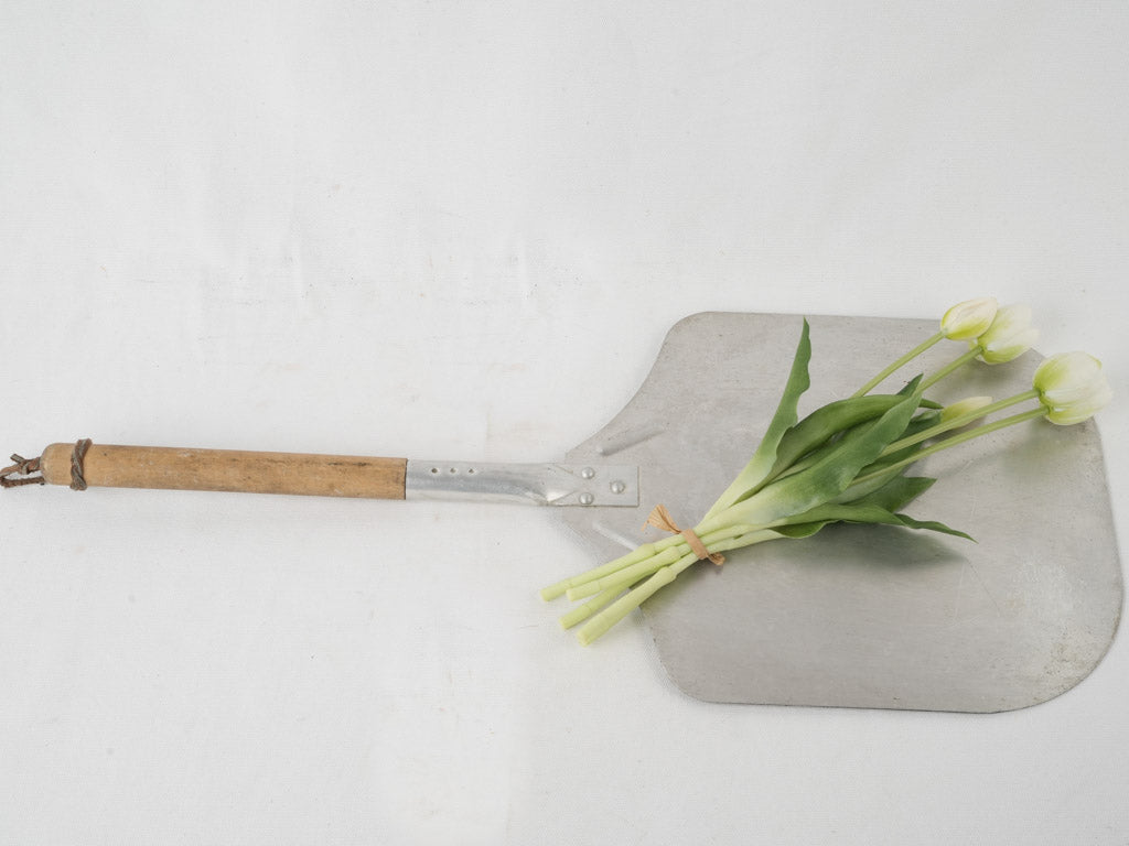 Weathered metal pizza turner with wood handle