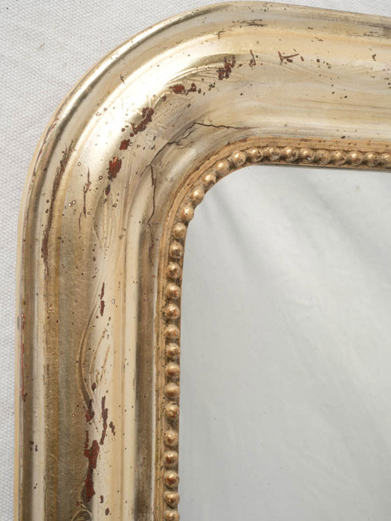 Silver-toned ornate mirror piece