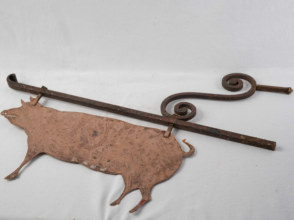 Playful vintage metal pig sign