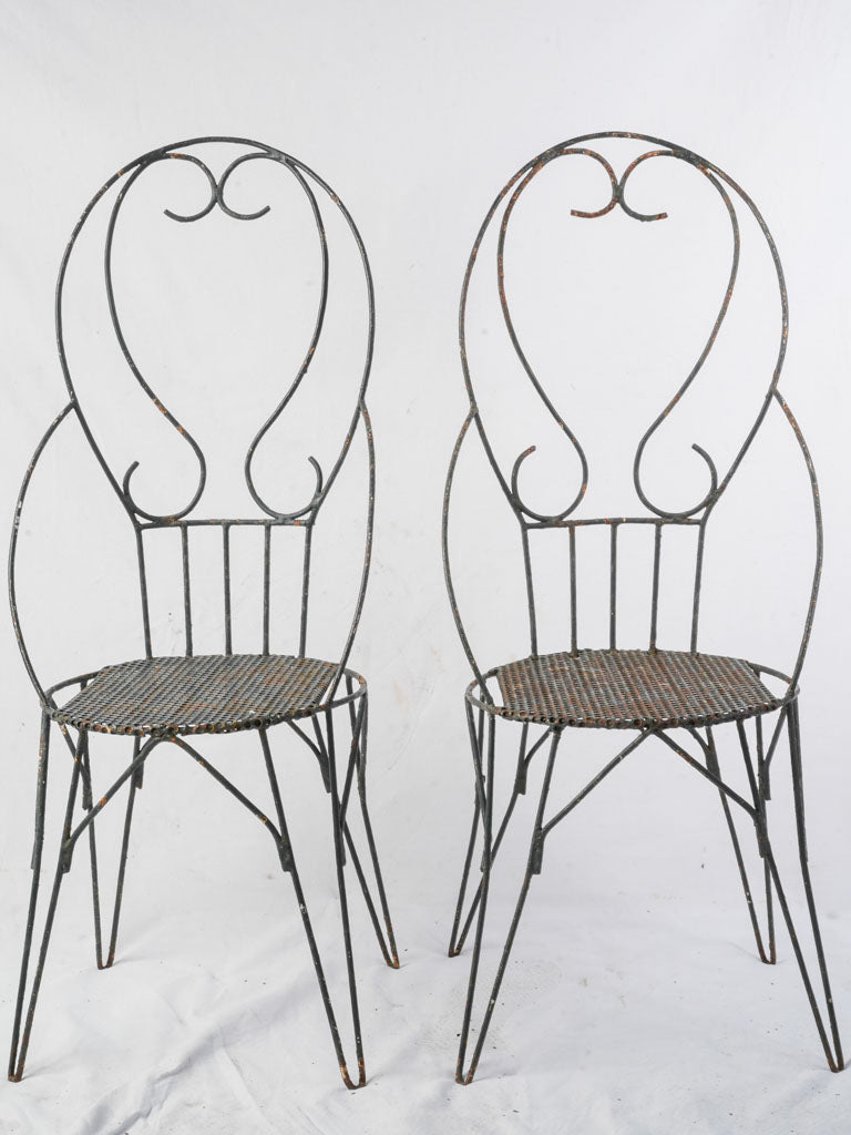 Intricate scrolling ironwork chairs