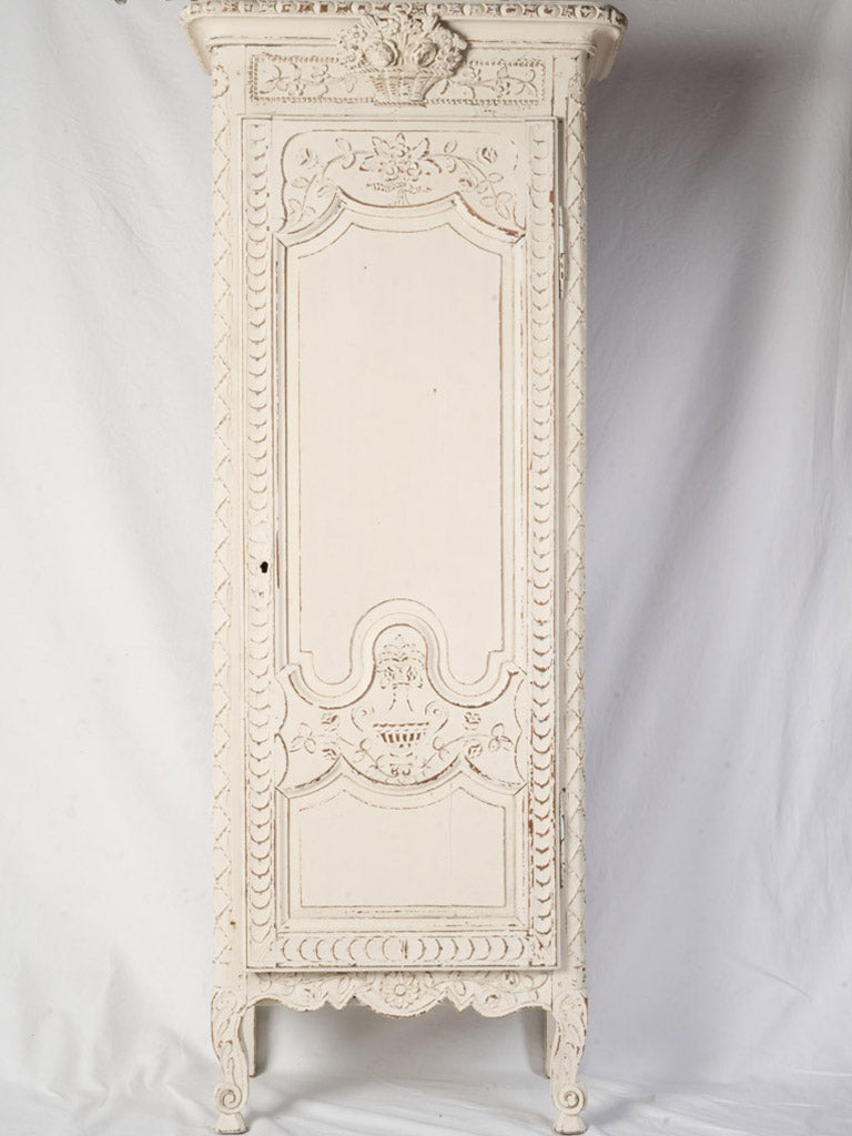 Antique slender wooden armoire.