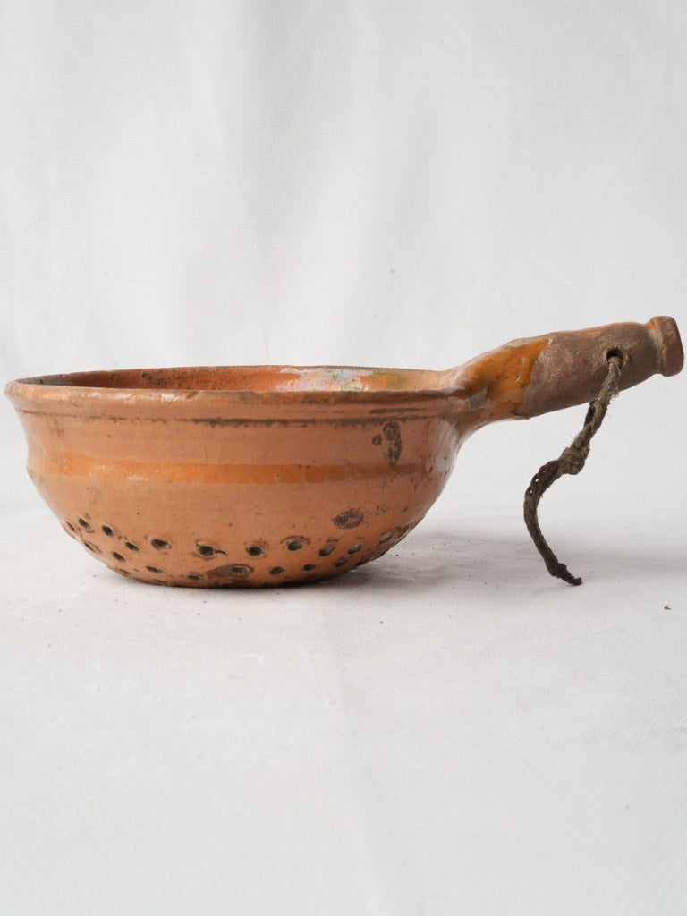 Warm olive-kiln speckled colander