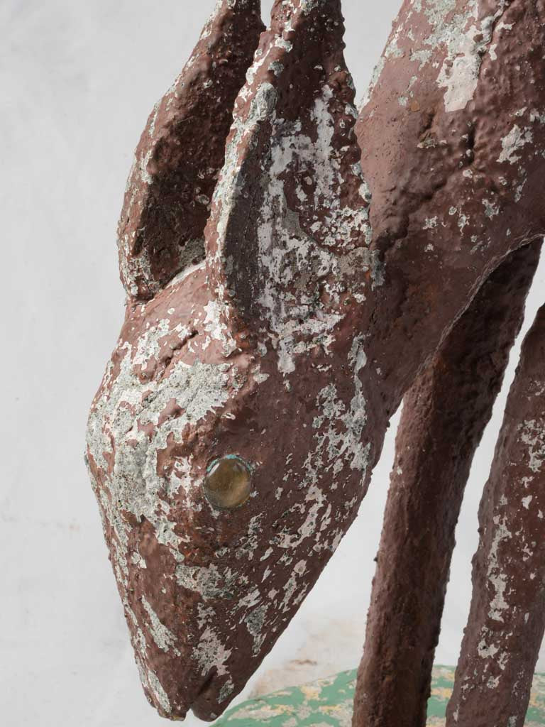 Weathered concrete fawn sculpture