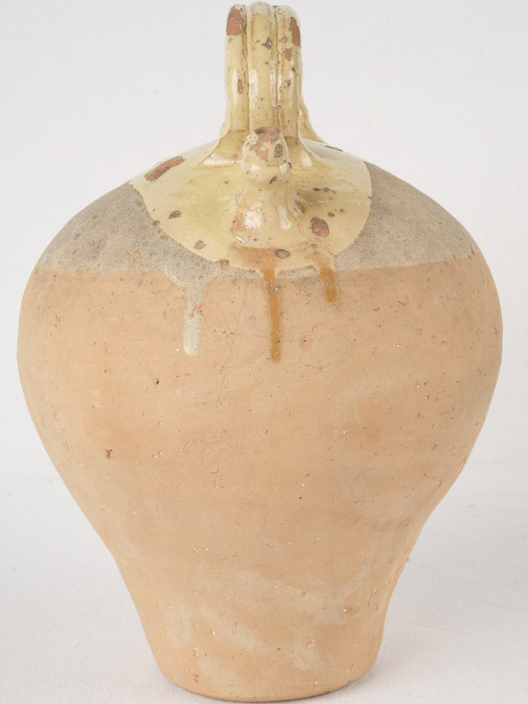 Pale yellow antique water bottle