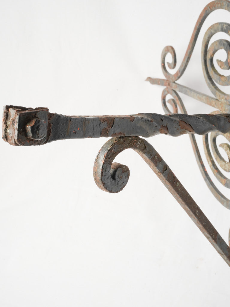 Charcoal-hued ironwork corner hanger