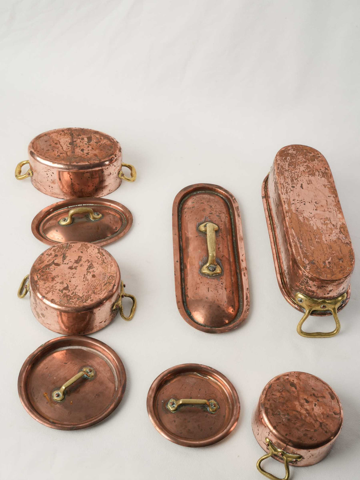 Set of four Copper Lidded Casseroles with Fish Kettle