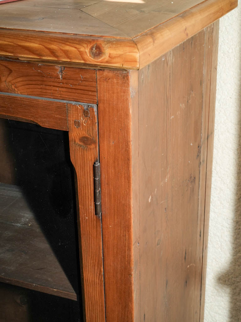 Aged glass-fronted wooden media cabinet