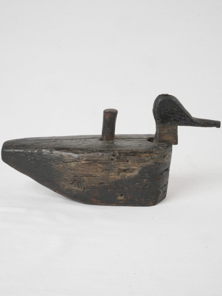 Stained vintage wooden duck sculpture