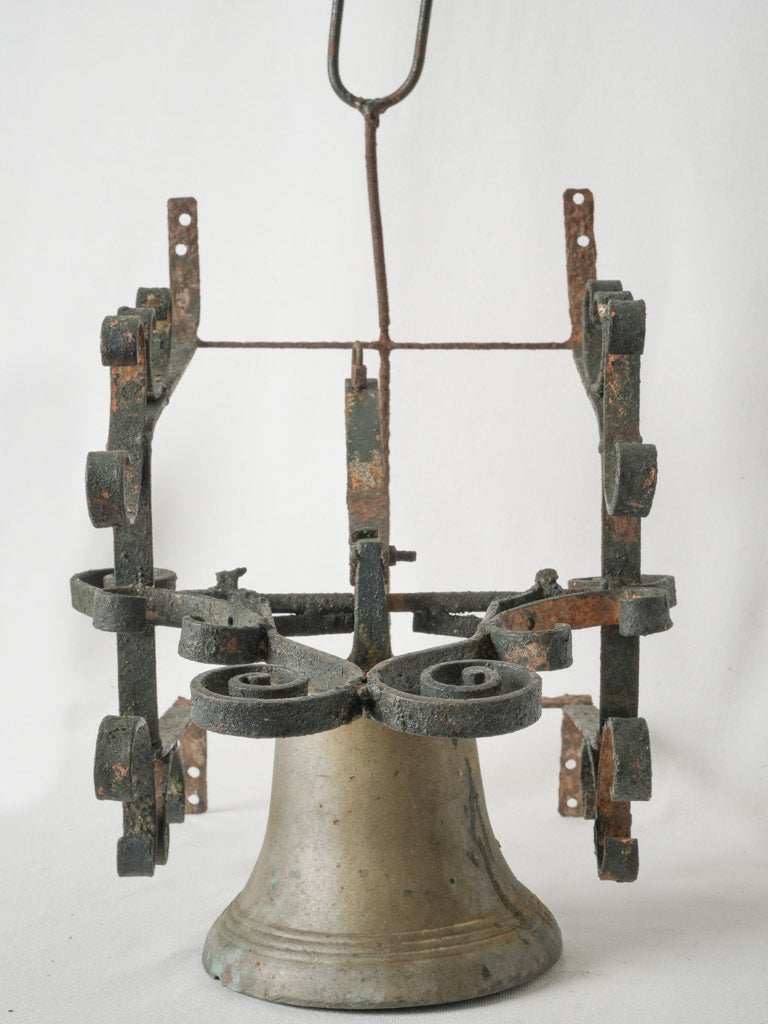 Aged bell on wrought iron bracket