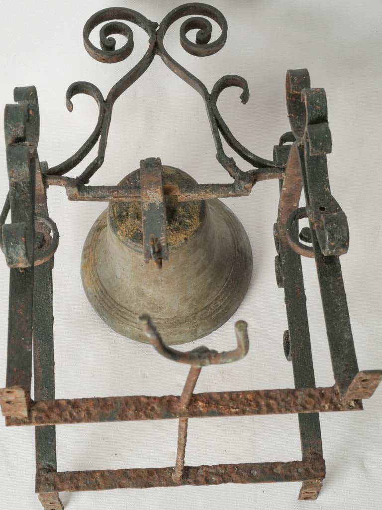 Aged bronze bell on rustic mount