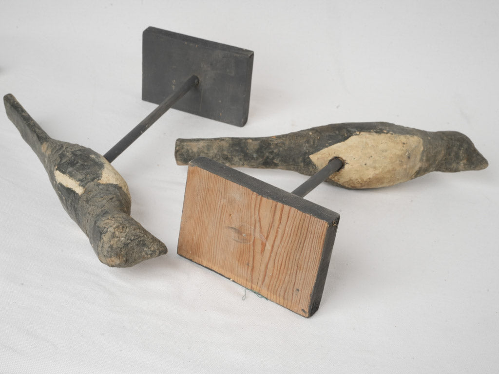 Stylized 19th-century bird deterrent figures
