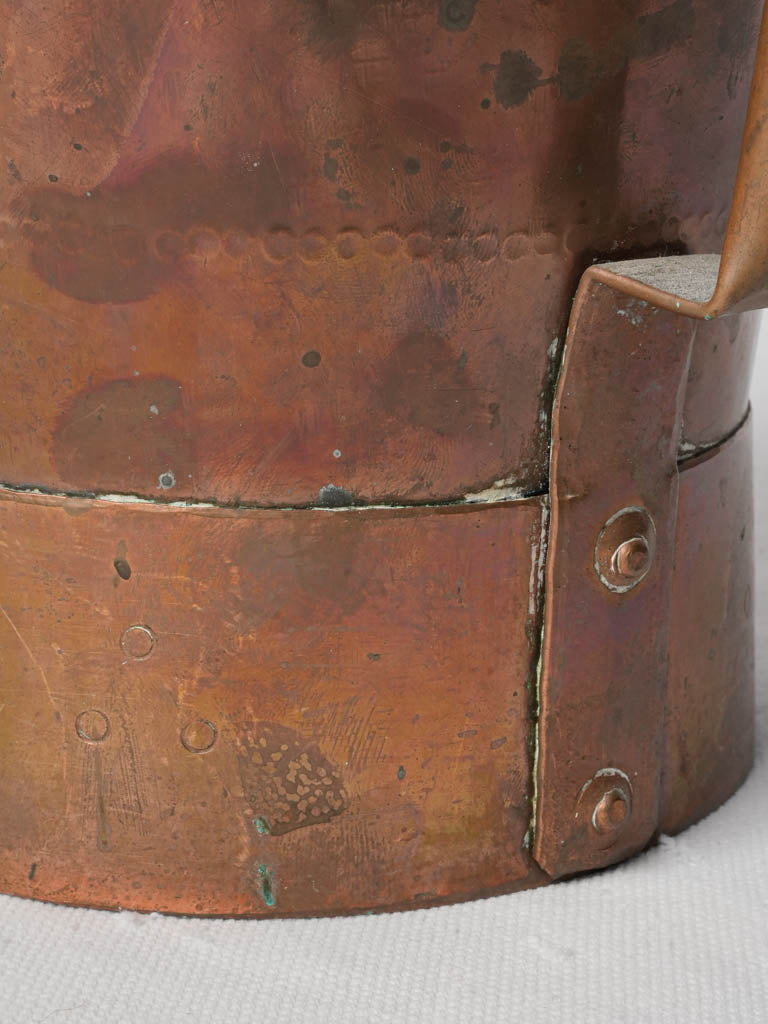 Patina-rich vintage copperware bucket
