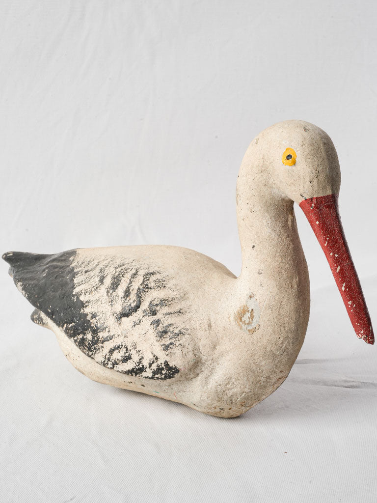 Charming aged cement stork decor