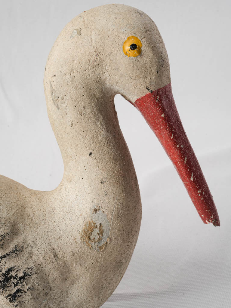 Weathered painted cement stork sculpture