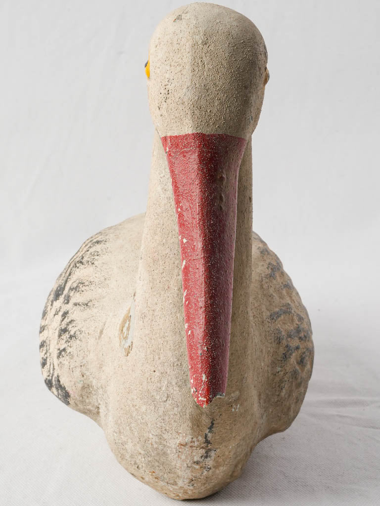 Timeworn red-beak cement ornament