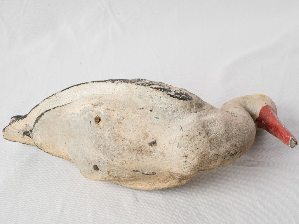 Aged ornate painted stork statue