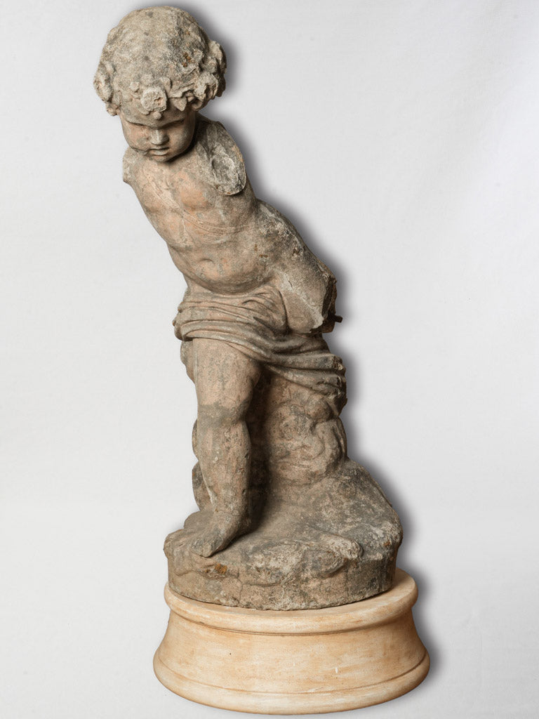 Rustic French limestone Cupid sculpture
