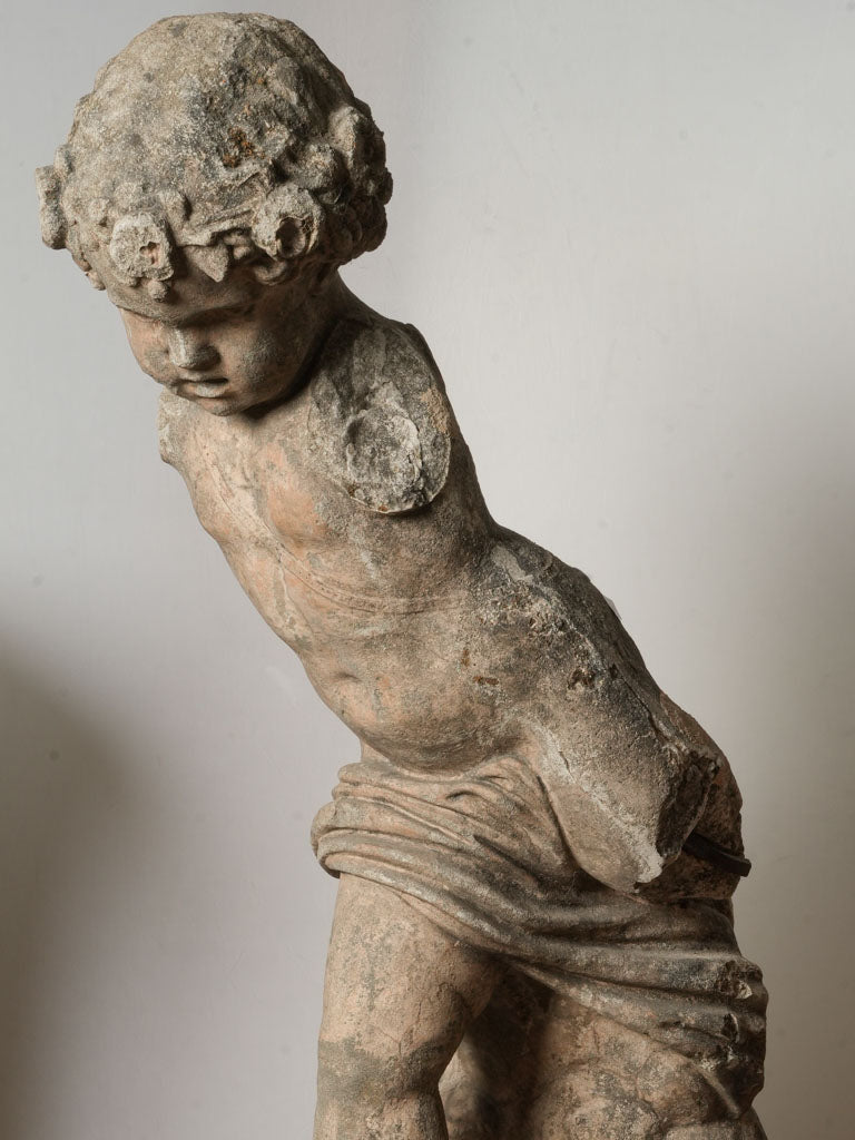 Authentic weathered limestone Cupid figure