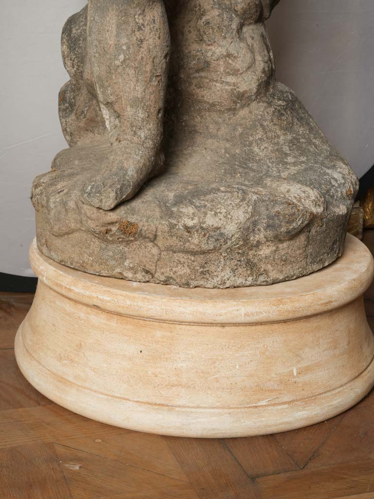 Evocative aged limestone Cupid decoration