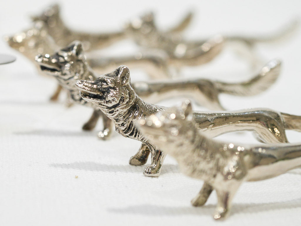 Ornate silver wolf knife holders