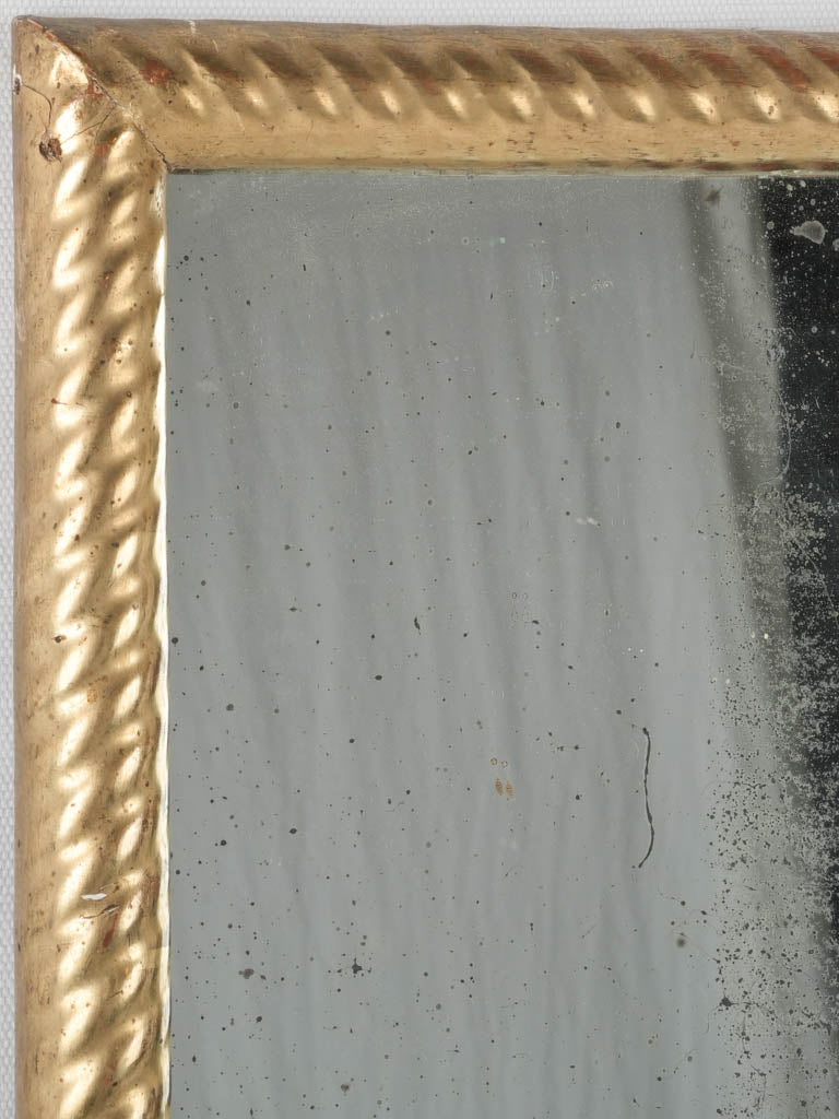 Directoire-period, aged, ornate mirror