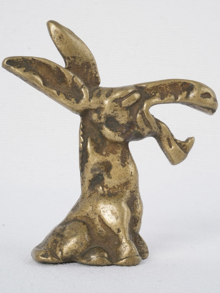 Aged, whimsical bronze bottle opener