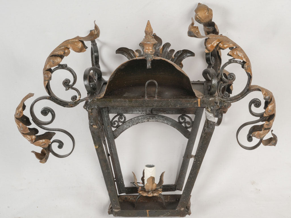 Curvaceous scrollwork lantern-shaped sconces