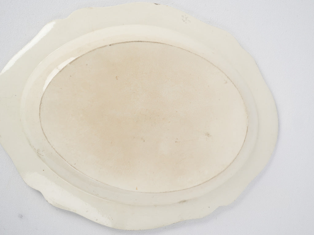 Well-loved, aged, antique, earthenware oval platter