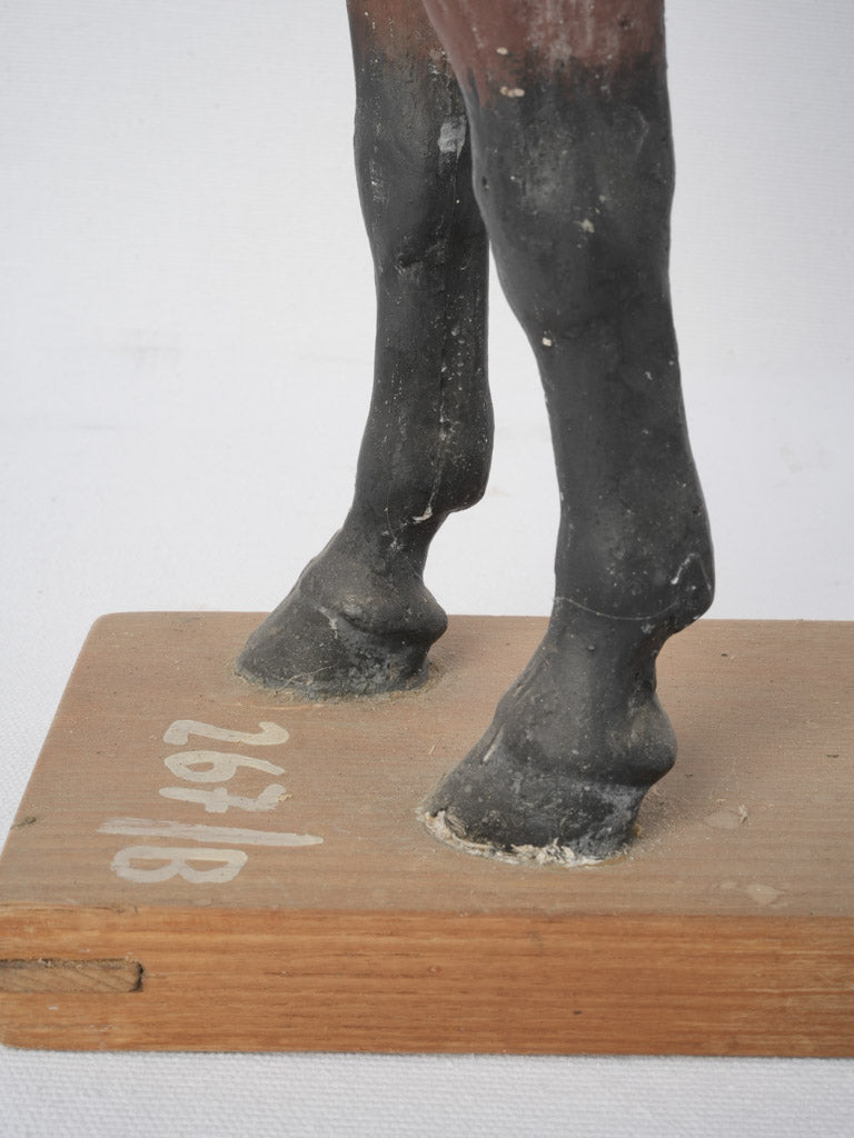 Aged brown and black horse figurine
