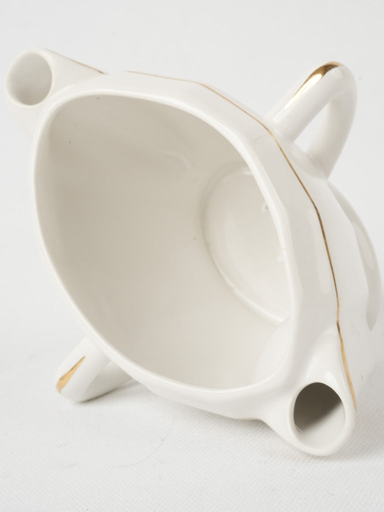 Charming gold-trimmed gravy sauce vessel