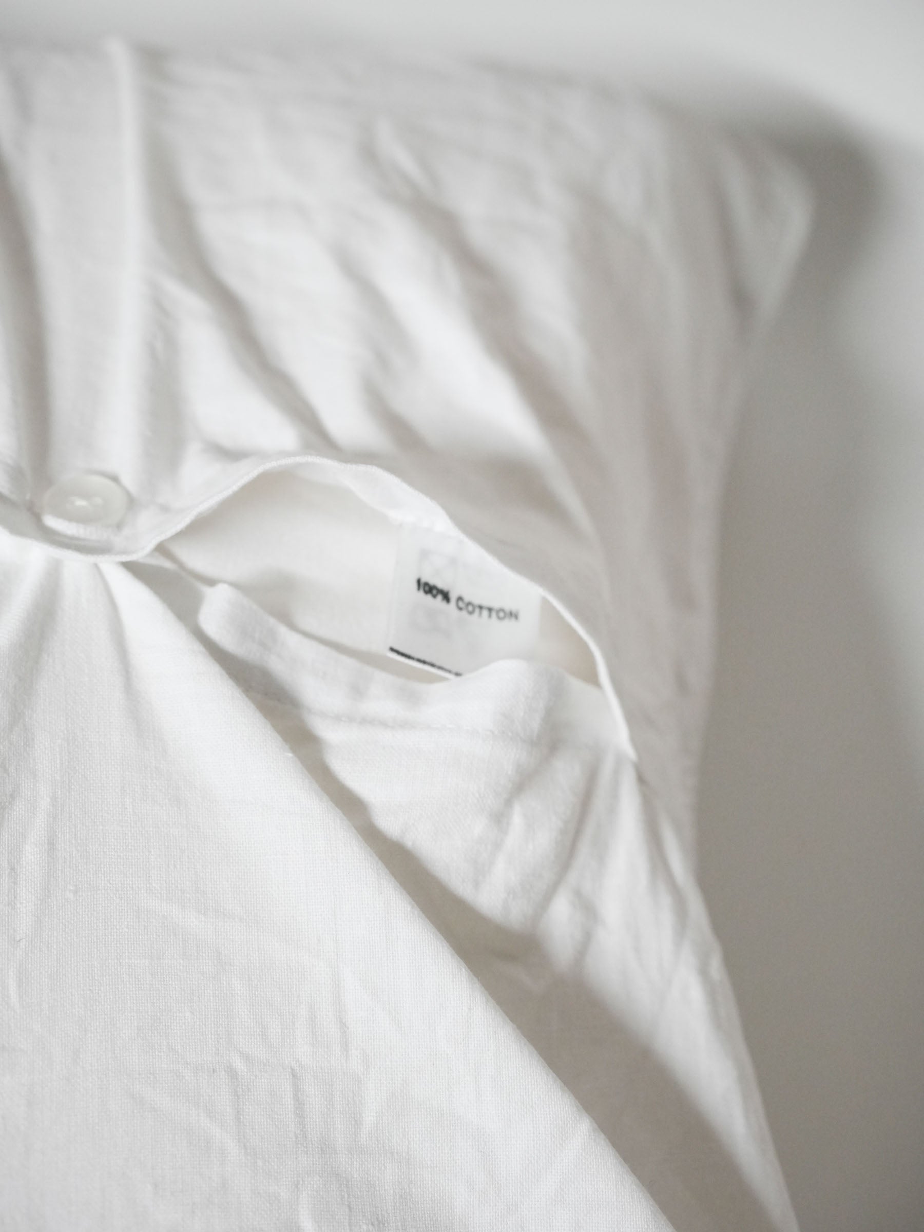 White pillowcase embroidered with colorful butterflies