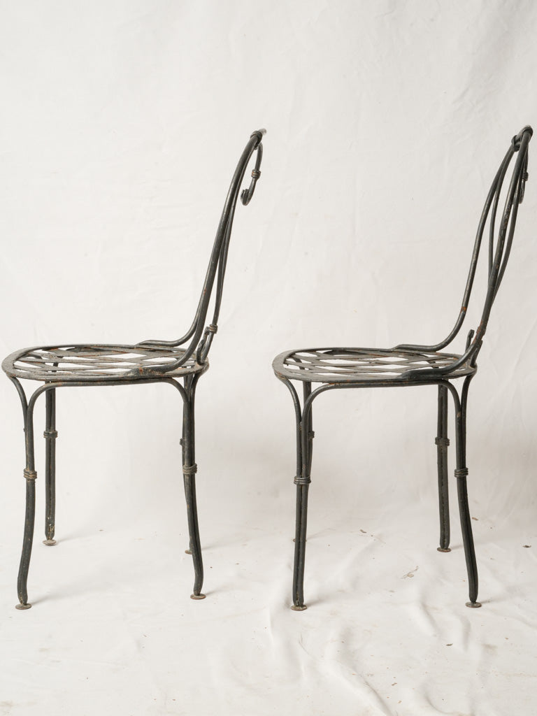 Elegant scroll-back wrought iron chairs