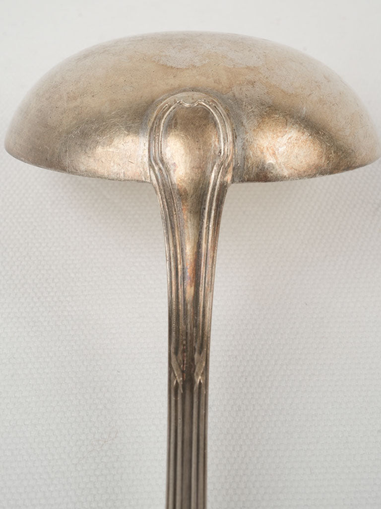 Aged silver-plated soup serving ladle