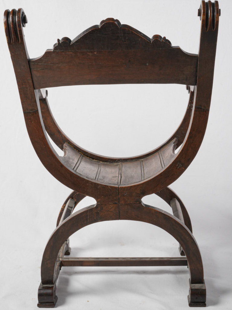 Graceful swooping X-frame chair