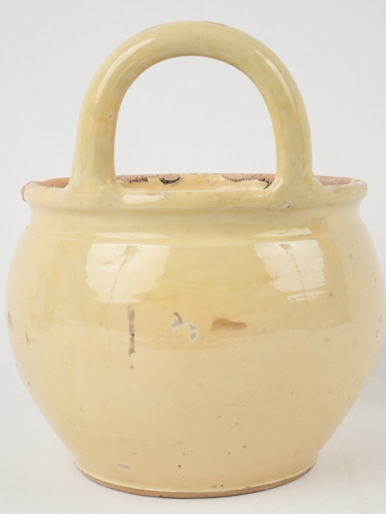 Happy pale yellow glazed wine vessel