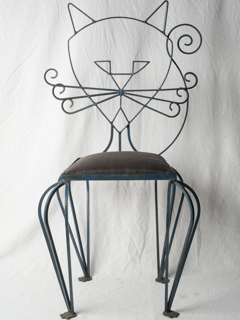 Deep blue finish wrought-iron chairs.