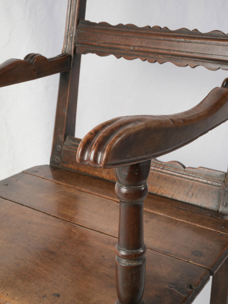Folk-inspired walnut armchair scalloped